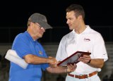 Bob Clement, a Lemoore Kiwanis member, honors Adventist orthopedic surgeon Dr. Christopher Verioti for providing professional medical coverage of the 51st annual Tulare-Kings All-Star Football game on June 23.